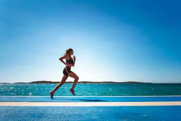 Woman running showing strong leg muscle Middlesex